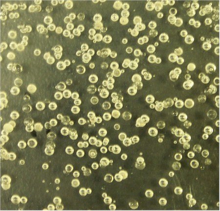Figure 1: Optical micrographs of fused quartz containing bubbles collected in an operating glass melting furnace.